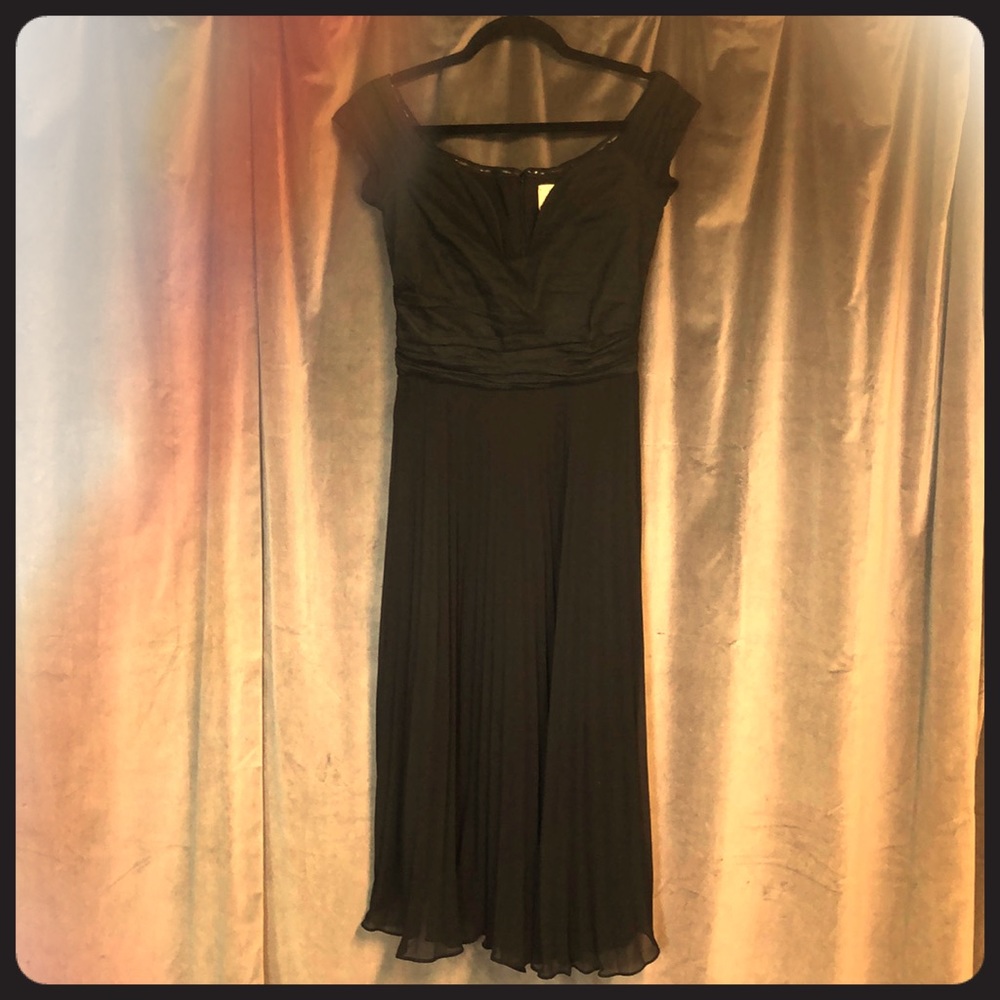 Black off the shoulder, low cut accordion dress